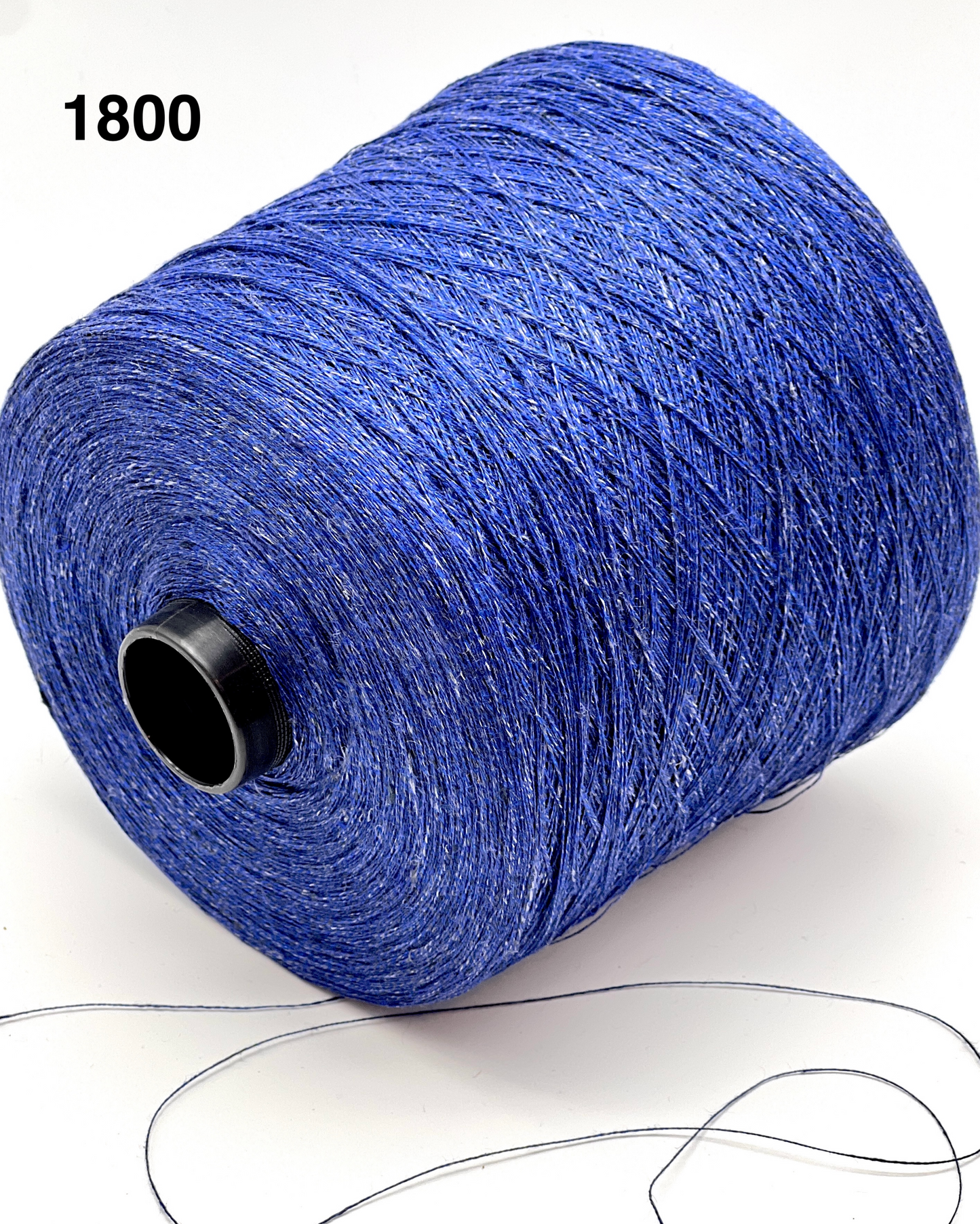 Blue spool of yarn with a black core on a white background