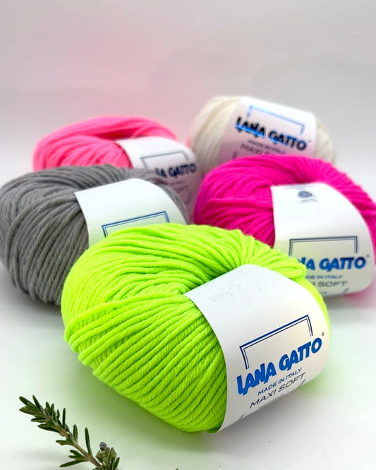 Balls of yarn in various colors with 'Lana Gatto' labels on a light background.