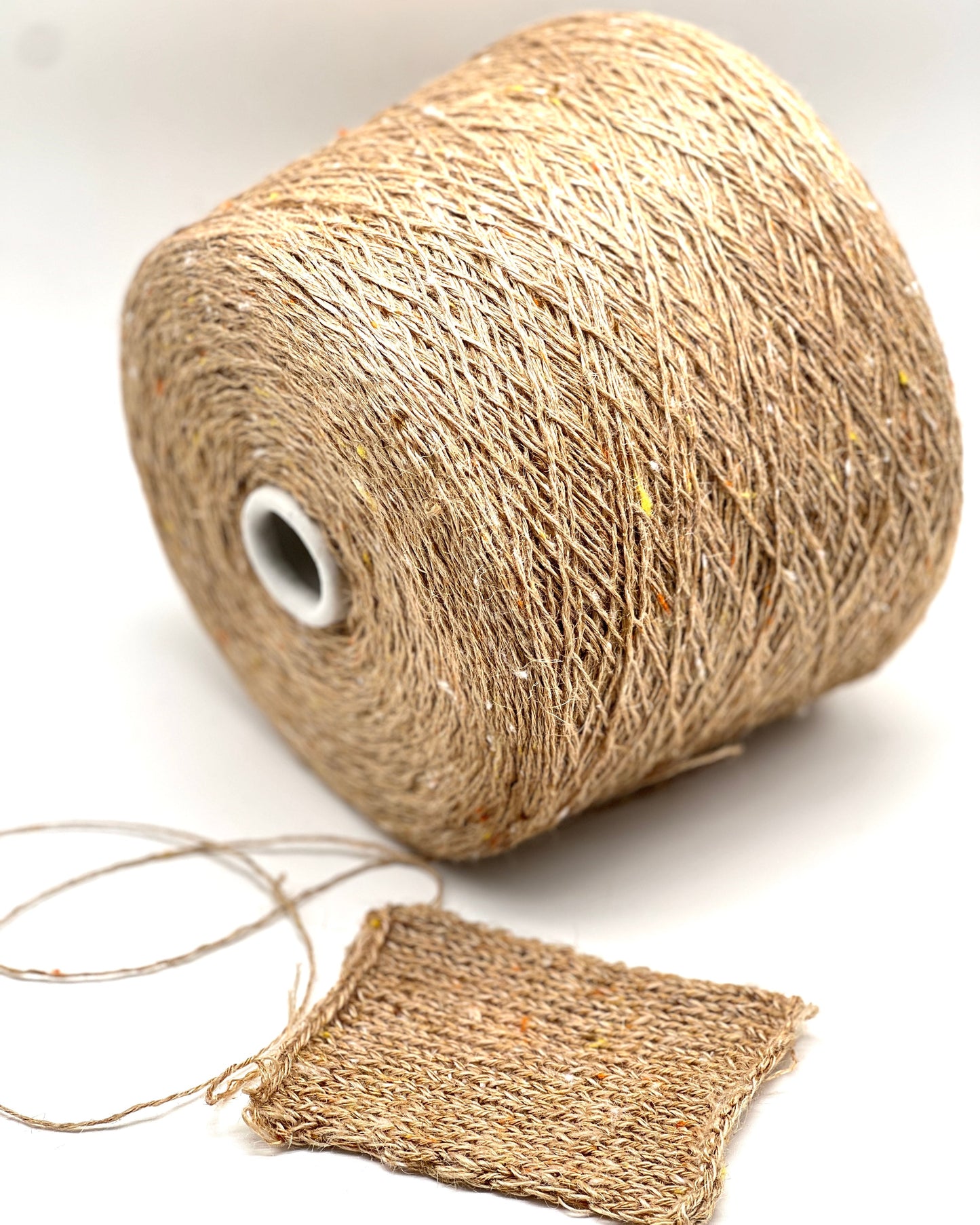 Spool of jute twine with a sample piece on a white background