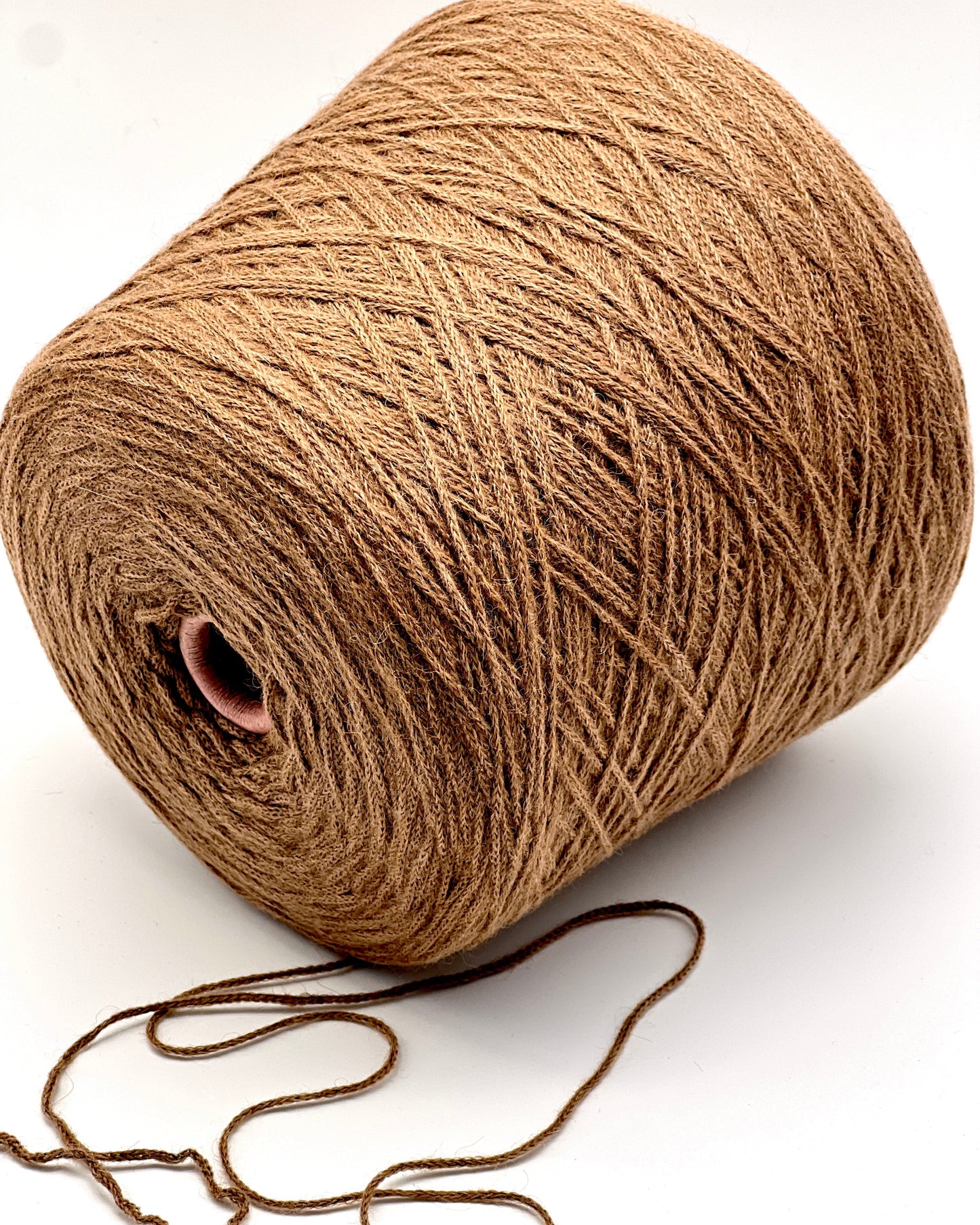 Brown yarn spool on a white background