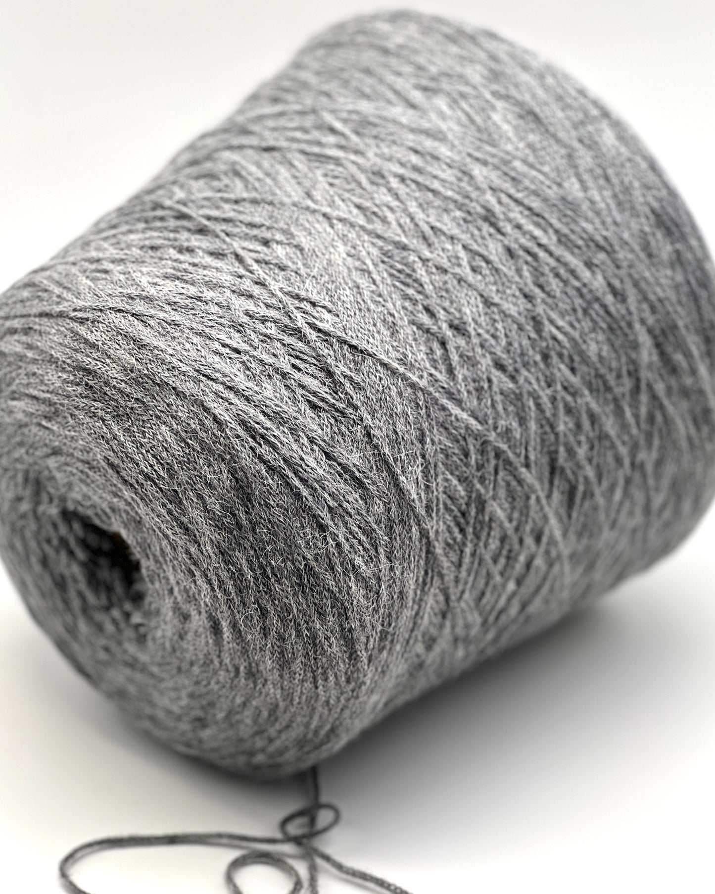 Close-up of a gray skein of yarn on a white background