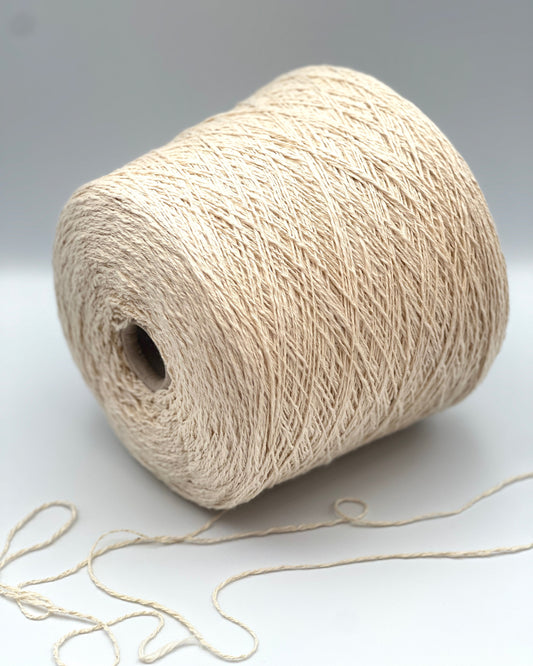 Cone of COTTON FLAME Italian flammé cotton yarn in natural cream color, premium sport weight cotton yarn for sweaters, cardigans, tops, and summer knitwear.