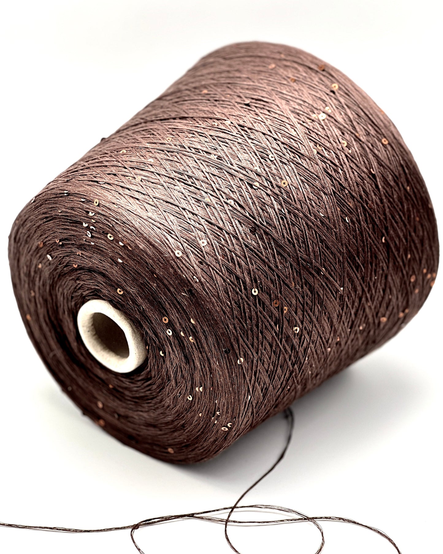 Spool of brown thread on a white background