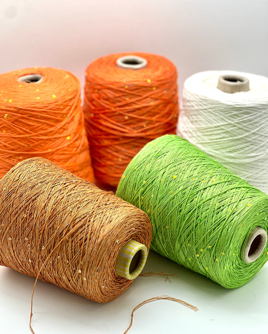 Five spools of yarn in orange, green, and brown on a white background