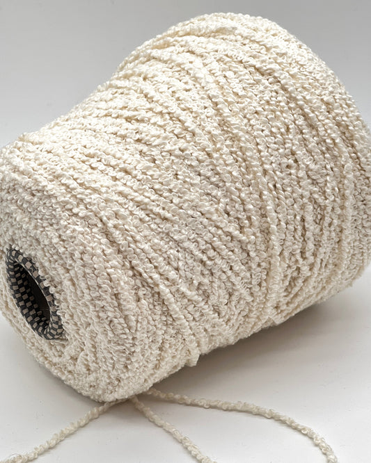 Italian cotton bouclé yarn on cone with looped textured surface