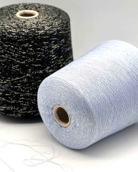 A luxurious cone of Pecci Filati SHIMMER yarn, a modern 50% Cotton, 25% Linen, 14% Polyester, and 12% Polyamide (Lurex) blend. The image showcases the refined metallic glow and delicate texture of this 3400m/100g Italian extrafine yarn, ideal for high-end blending. Authentic luxury fiber available at iDOKNiT.com.