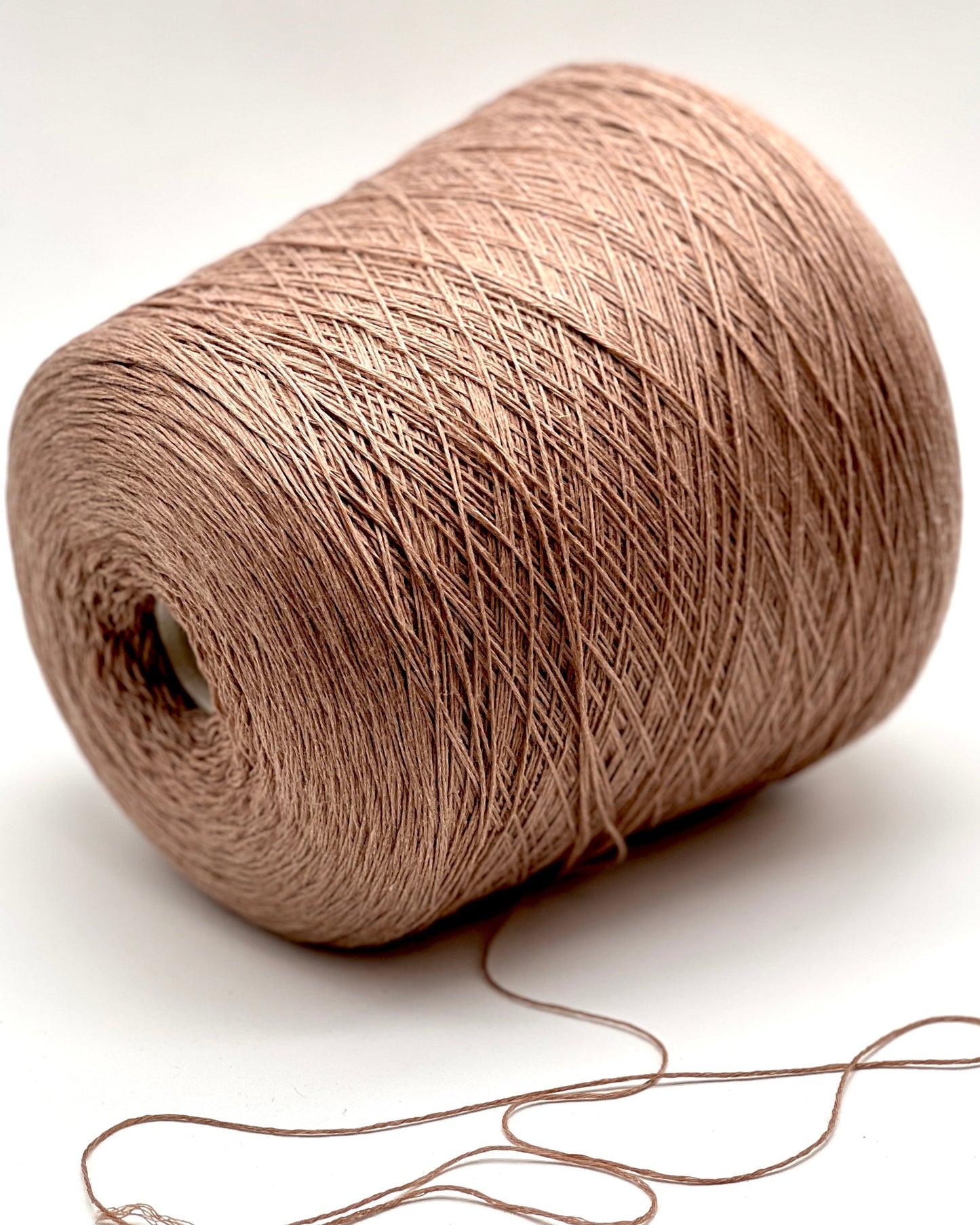 Brown yarn spool on a white background
