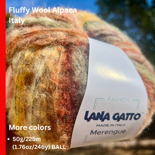 Ball of fluffy wool yarn with a Lana Gatto label against a blurred natural background