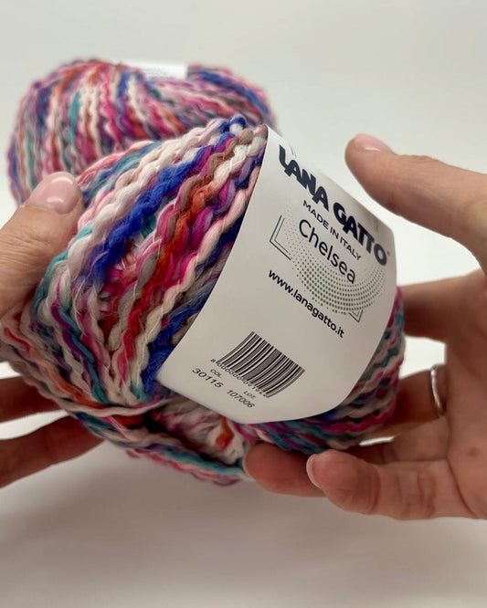 Multicolored yarn ball with a label on a white background