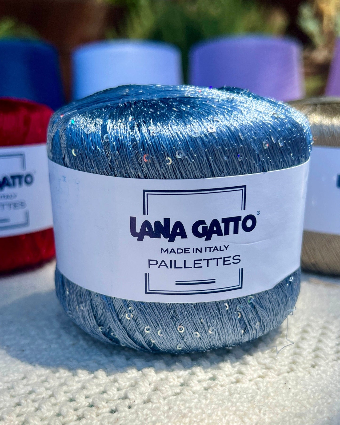 Lana Gatto Paillettes yarn in shimmering pastel tones, with delicate 2mm sequins, lightweight polyester yarn ideal for adding sparkle to knit or crochet projects. Made in Italy. 8604 Blue color.
