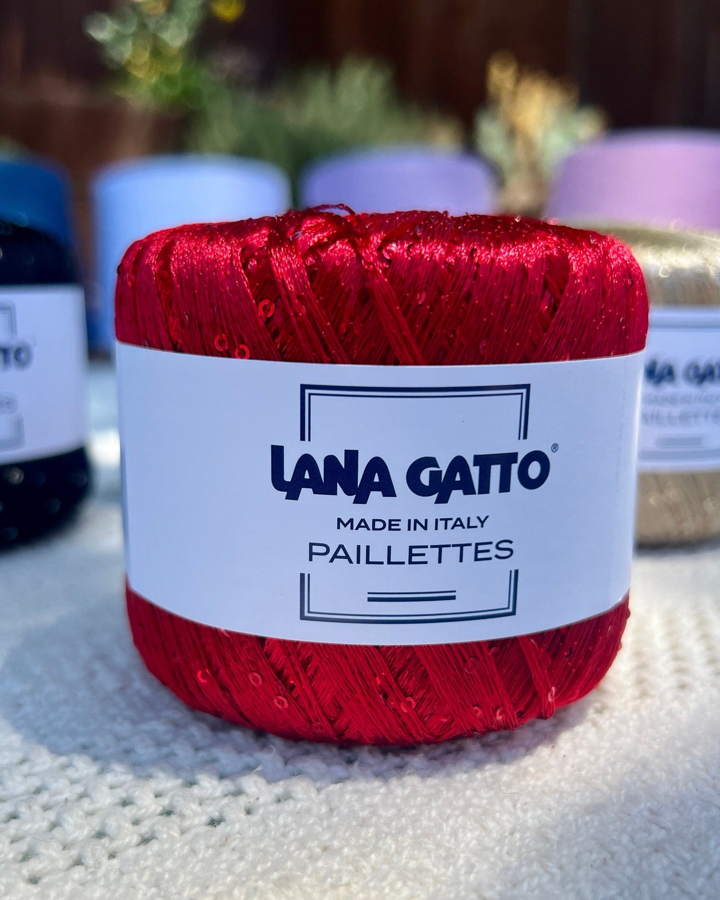 Lana Gatto Paillettes yarn in shimmering pastel tones, with delicate 2mm sequins, lightweight polyester yarn ideal for adding sparkle to knit or crochet projects. Made in Italy. 30101 Red color.
