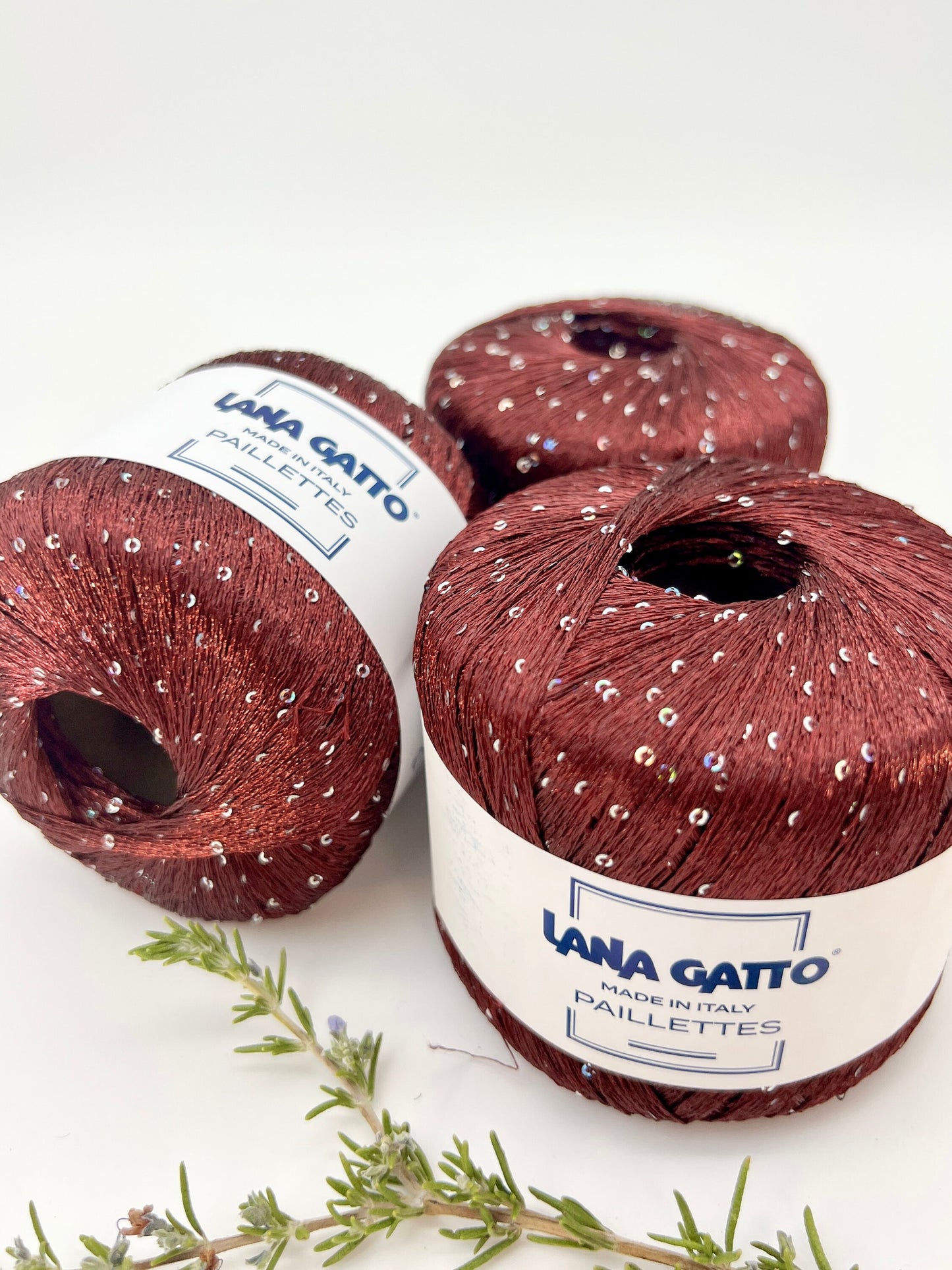 Lana Gatto Paillettes yarn in shimmering pastel tones, with delicate 2mm sequins, lightweight polyester yarn ideal for adding sparkle to knit or crochet projects. Made in Italy. 30102 bordo color.