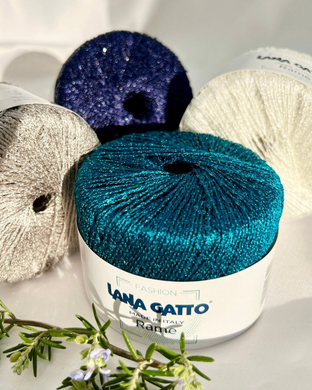 Yarn balls with 'Lana Gatto' branding on a white background