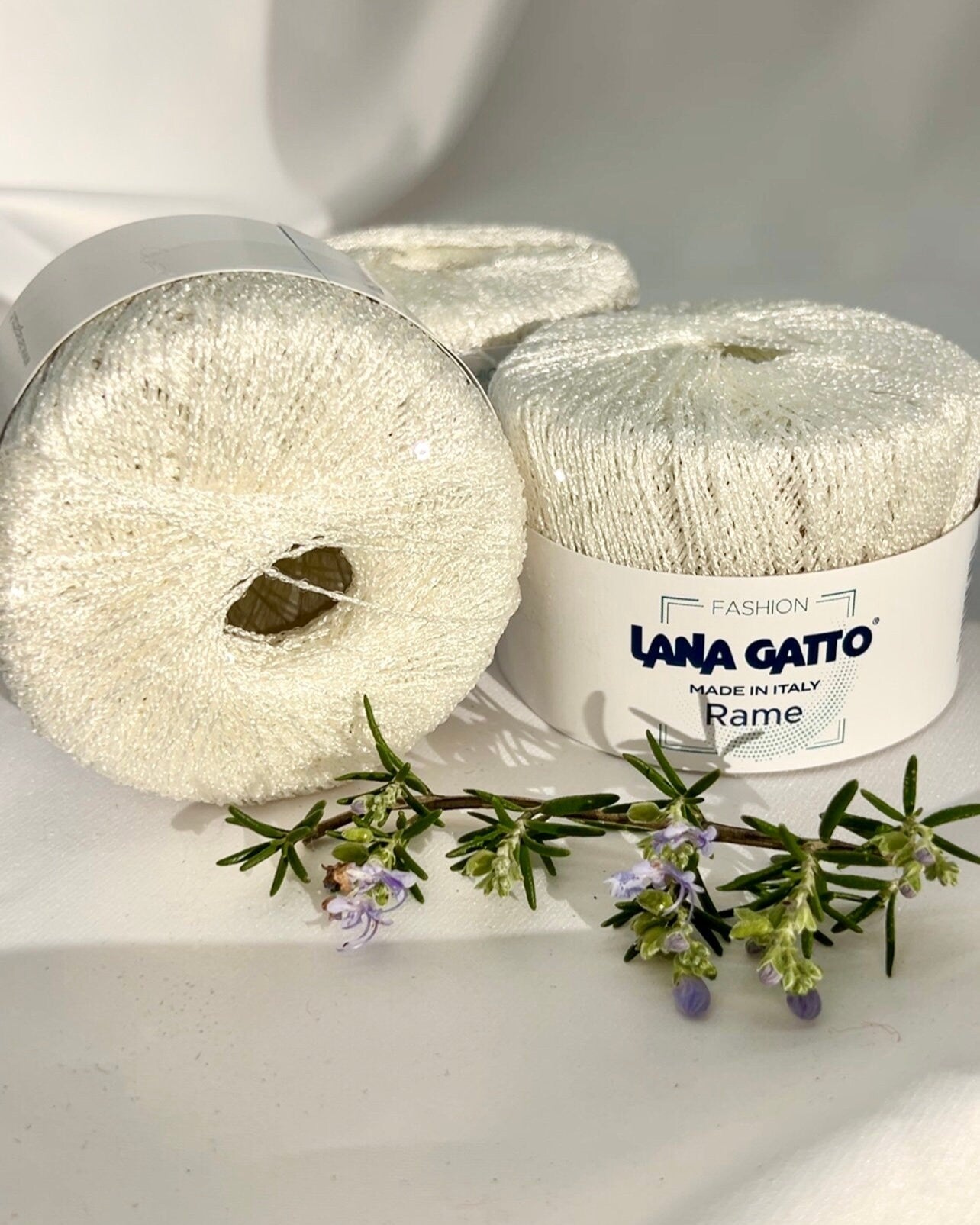 Three balls of yarn with 'Lana Grossa' branding on a white background