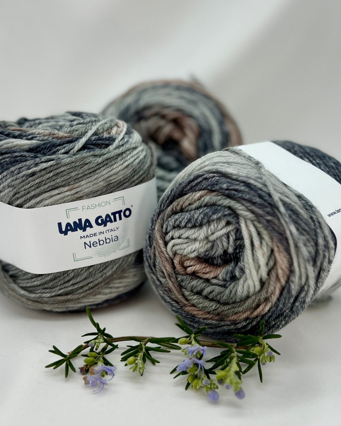 Three skeins of yarn with 'Lana Gato' labels on a white background