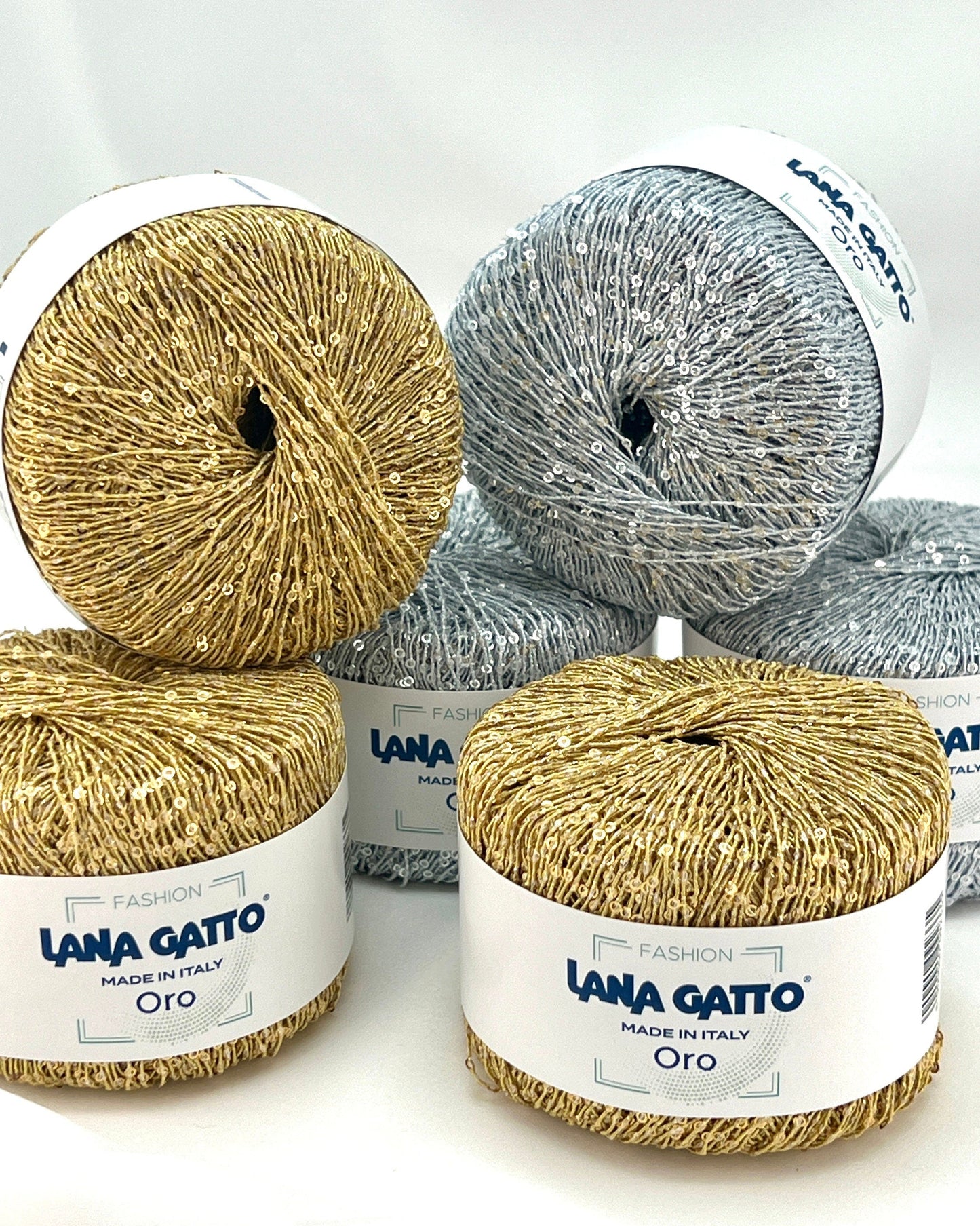 Yarn balls with 'Lana Gatto' labels on a white background