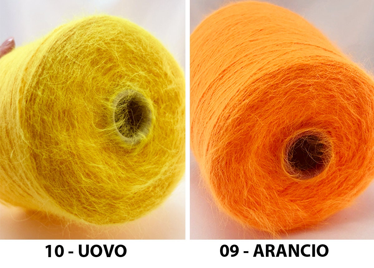 Two rolls of yarn, one yellow labeled '10 - UOVO' and one orange labeled '09 - ARANCIO', on a white background.