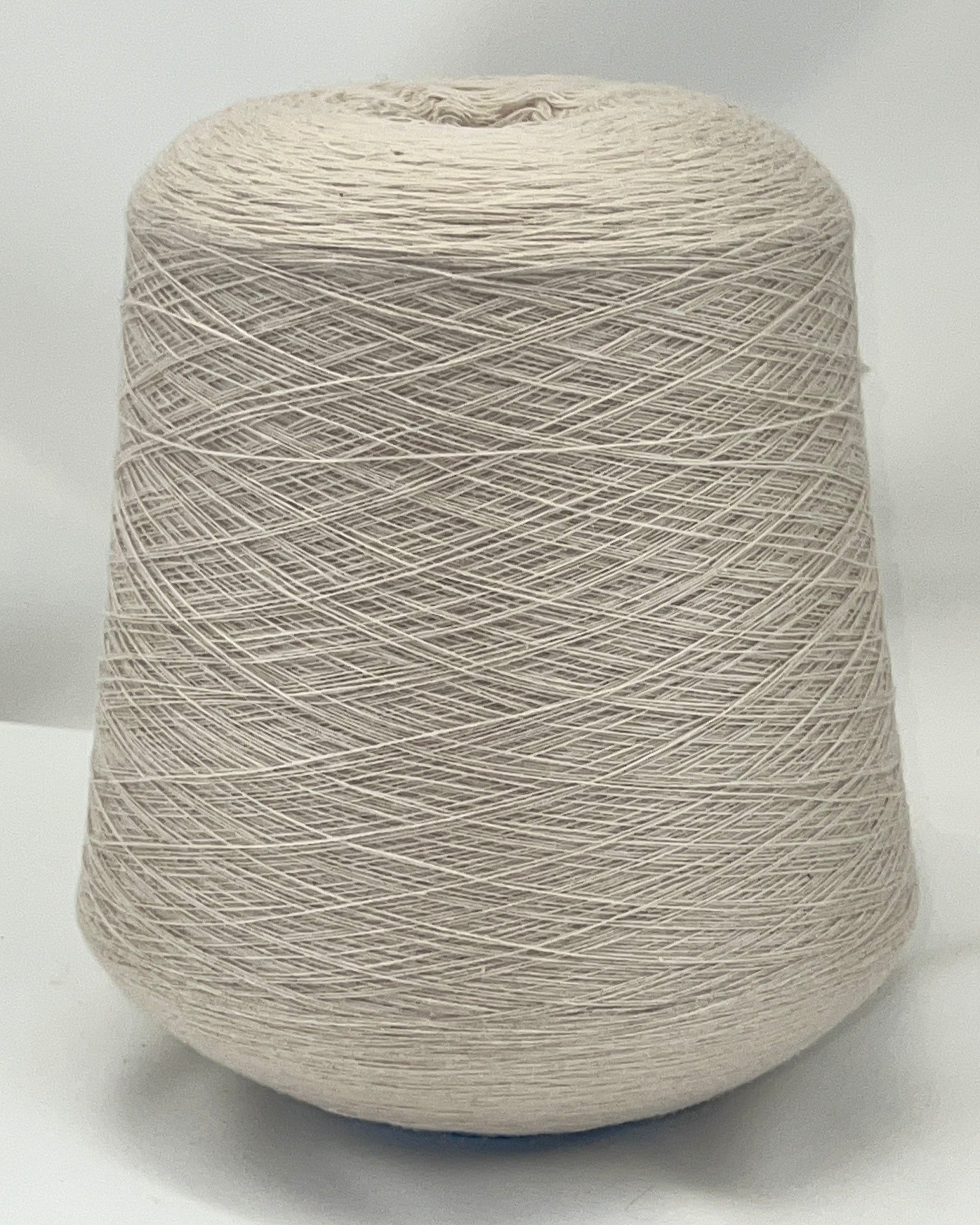 Large spool of beige yarn on a white background