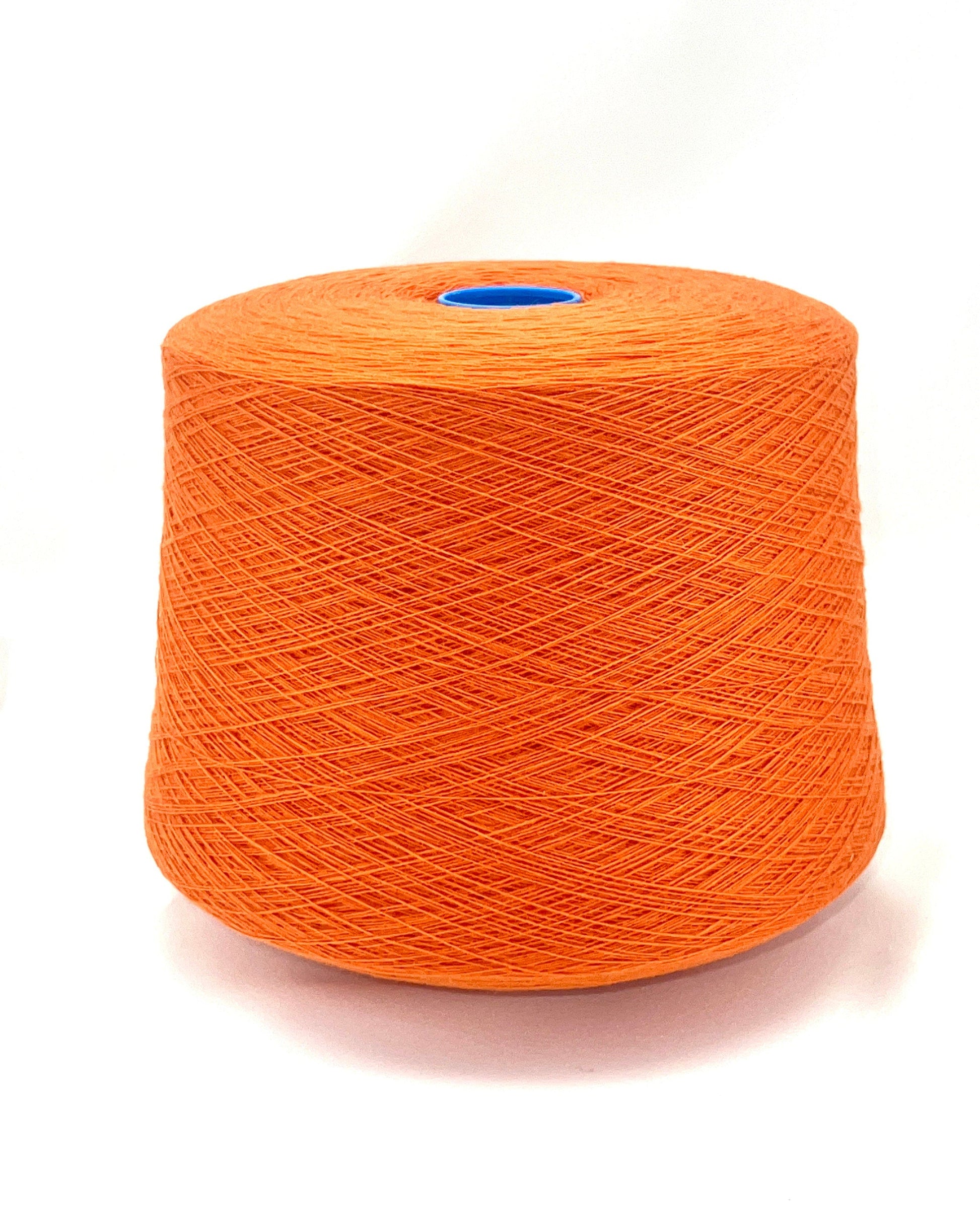 Orange spool of yarn on a white background