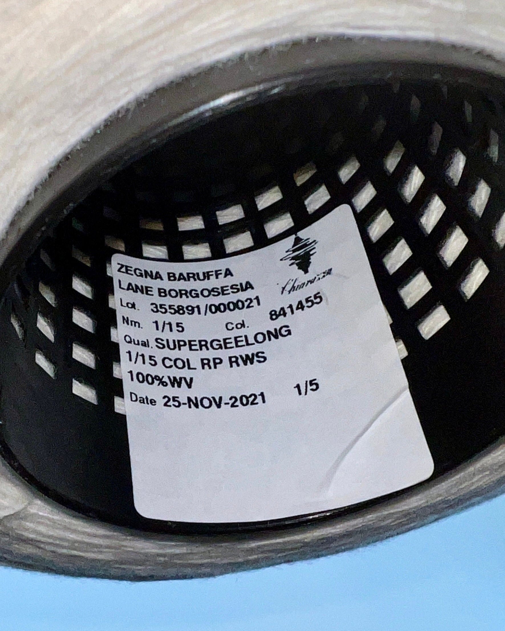 Close-up of a label inside a shoe with text and a logo.