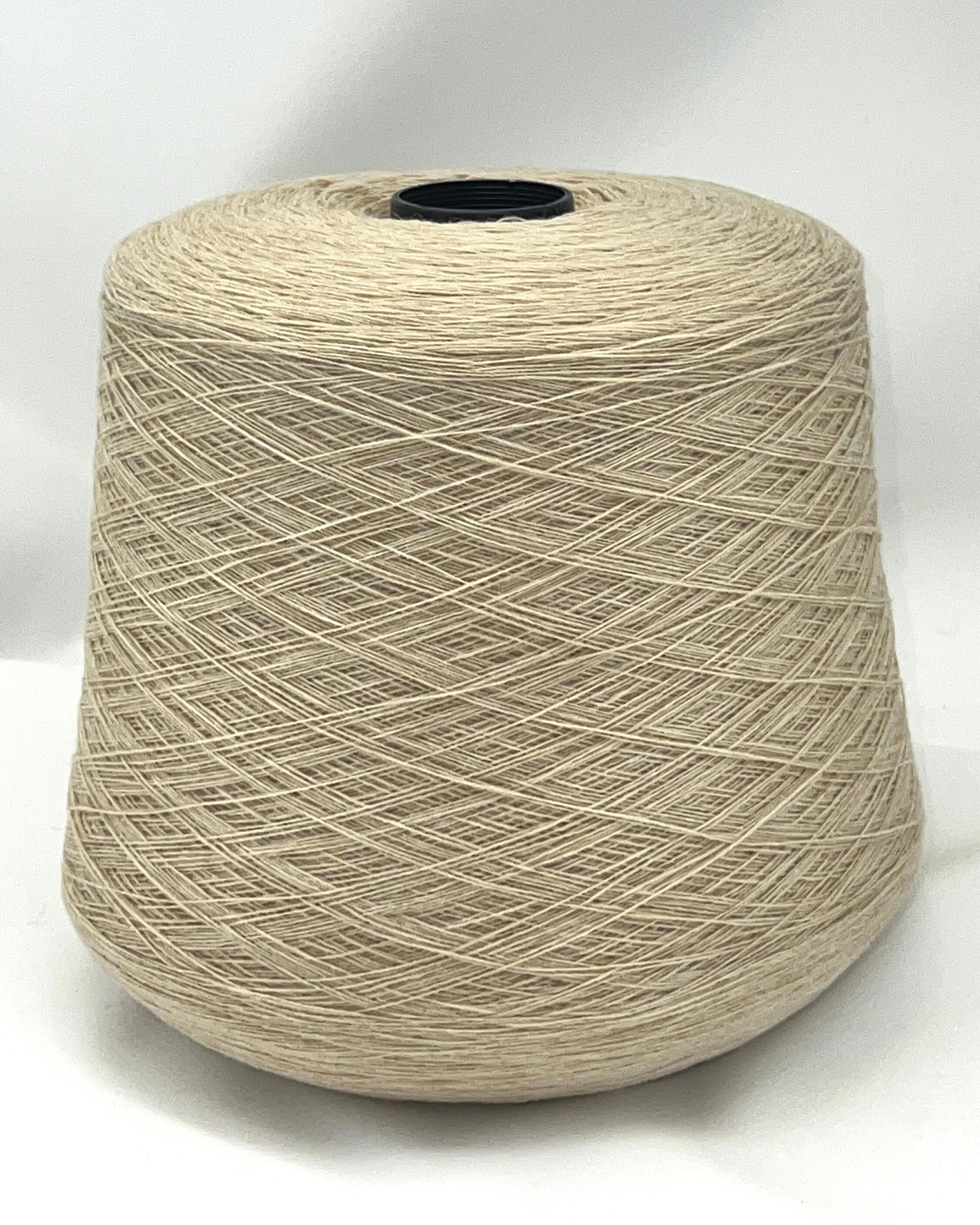 Spool of beige yarn on a white background
