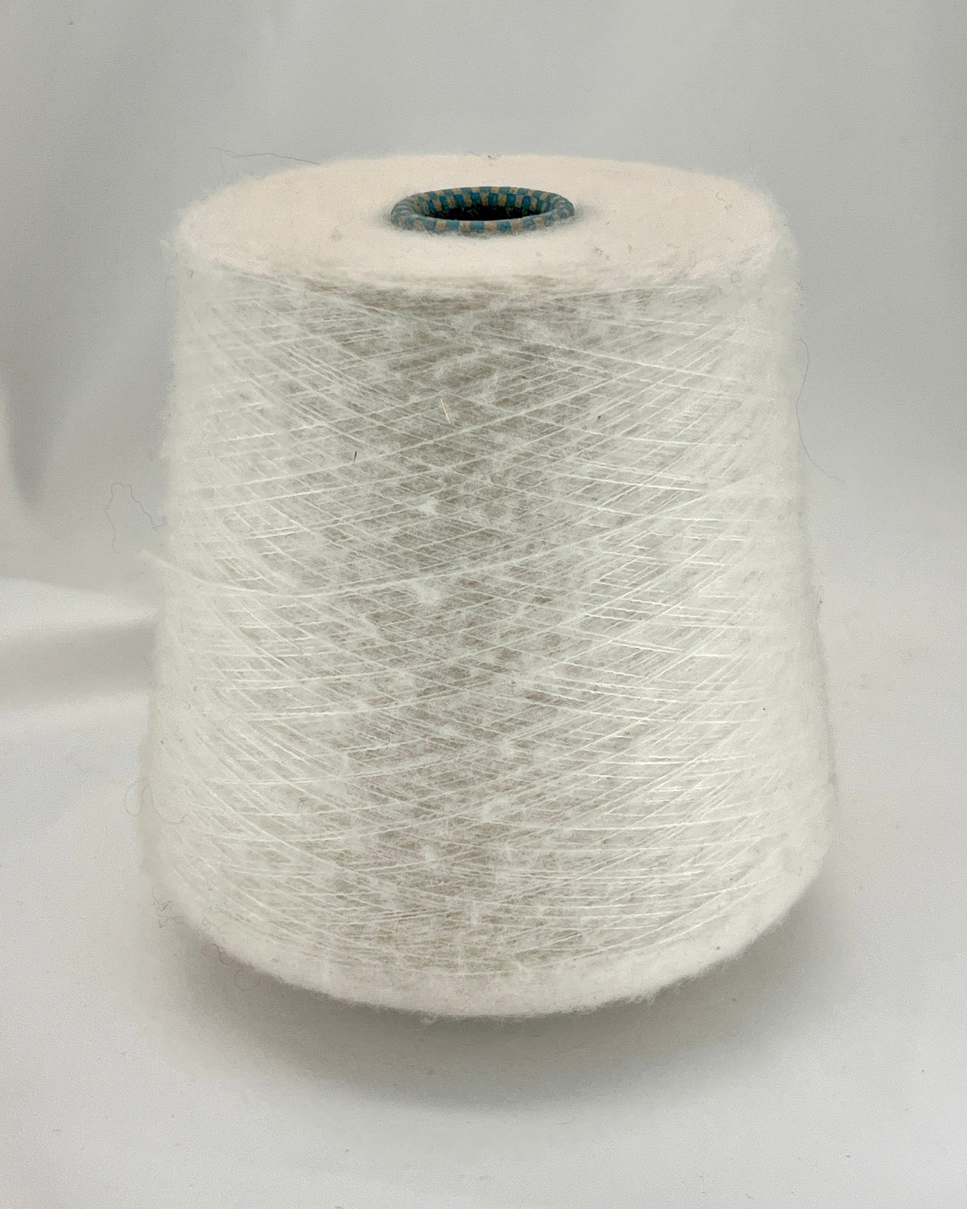 Spool of gray yarn on a light gray background