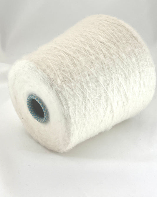 Spool of white yarn on a light gray background