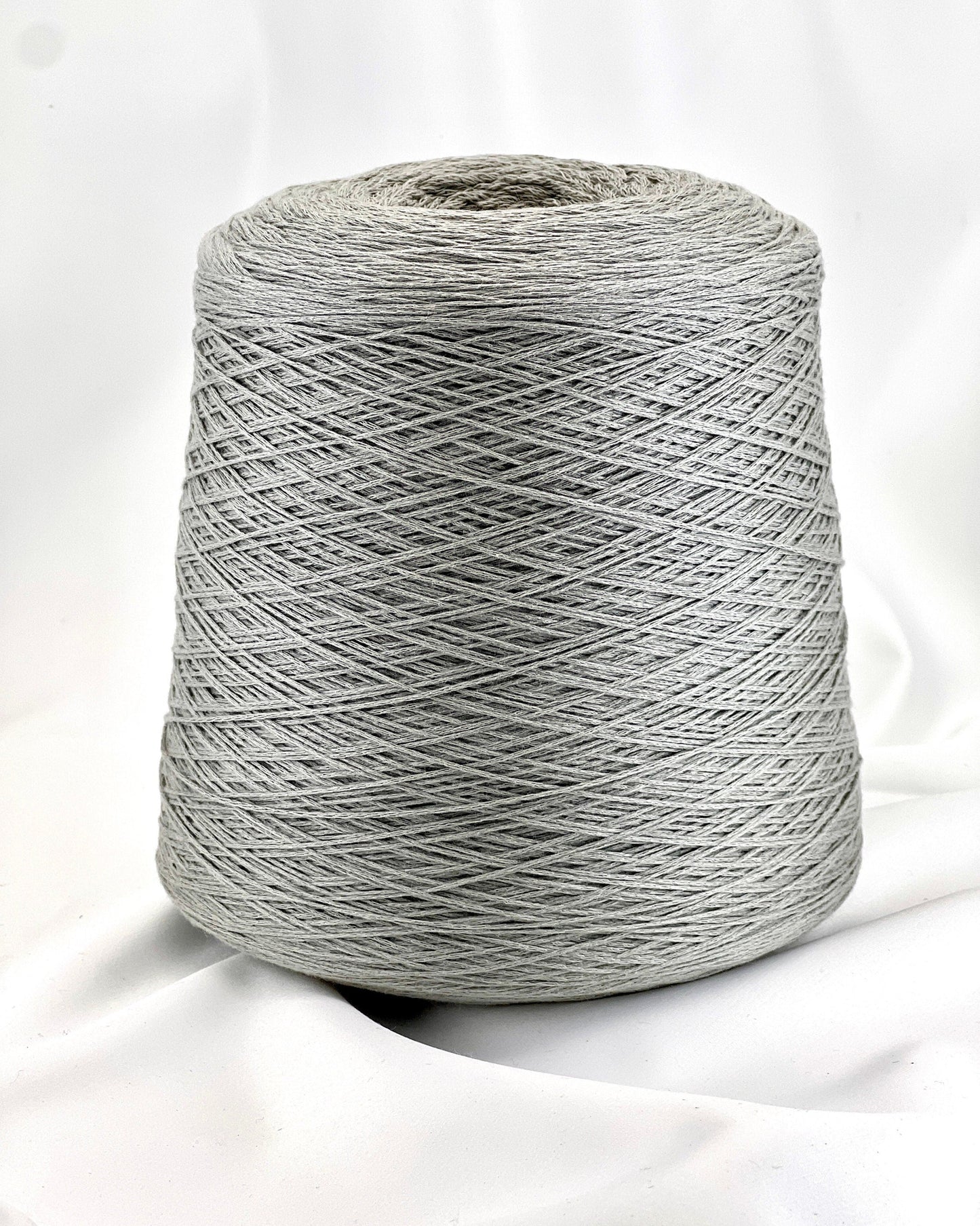 Gray spool of yarn on a white background