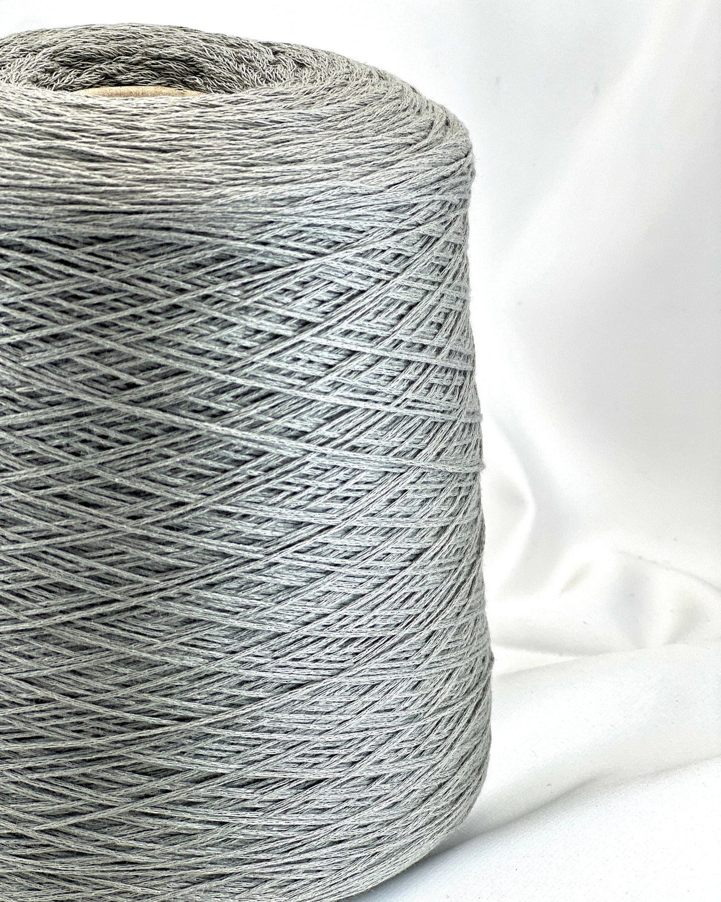 Spool of gray thread on a white background