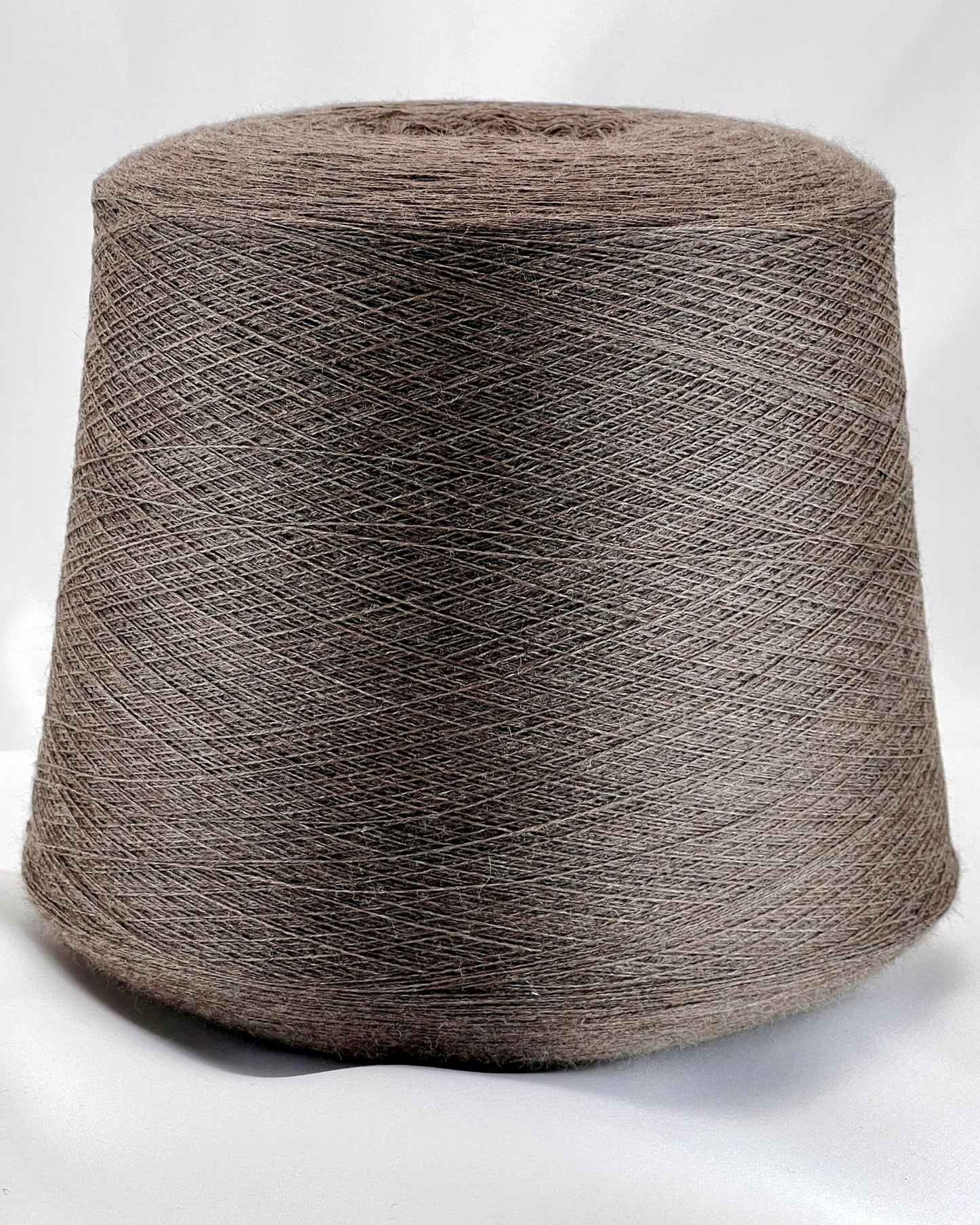 Large spool of brown yarn on a white background