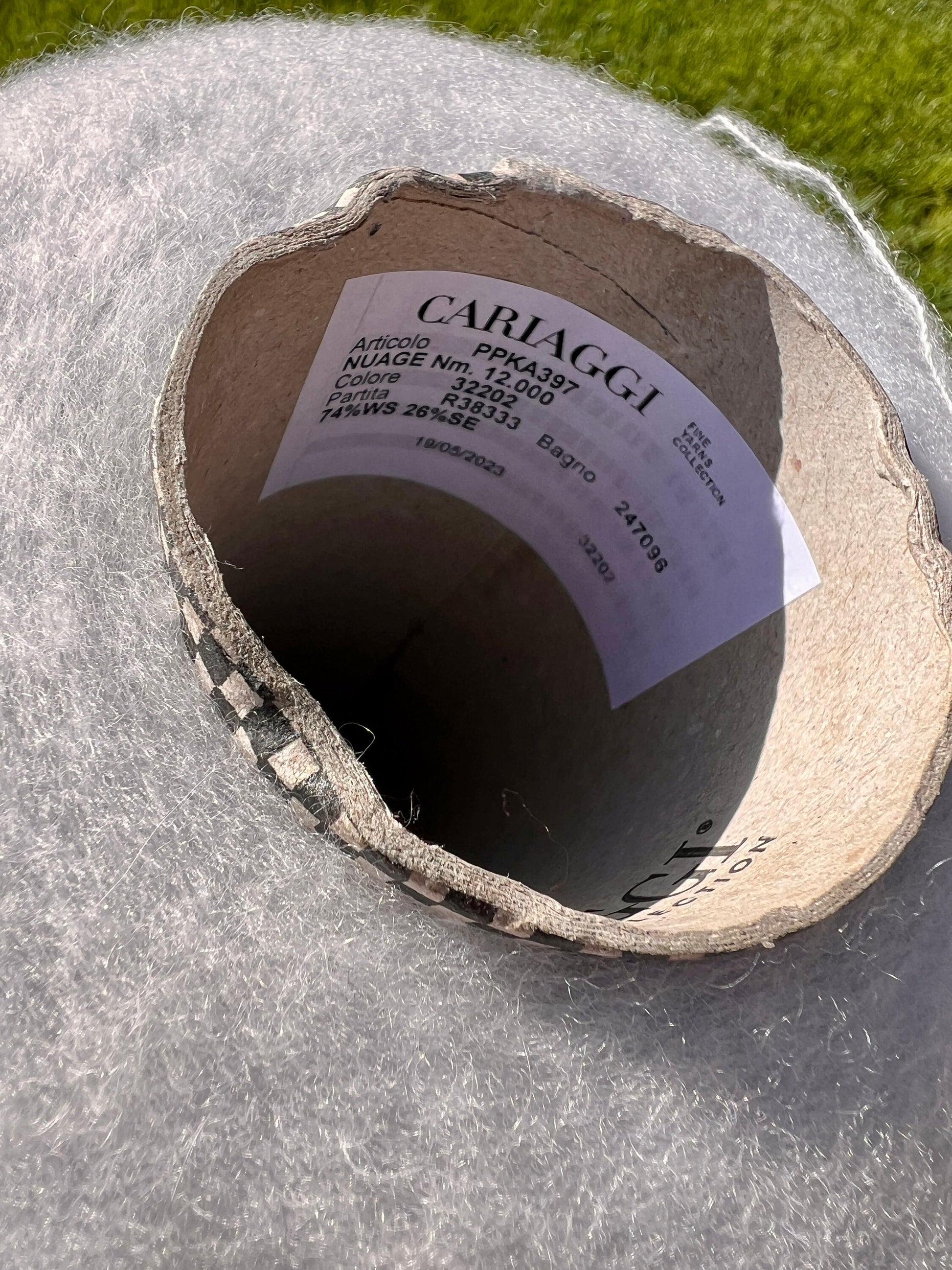 Cardboard tube with CARLAGGI label on a gray surface