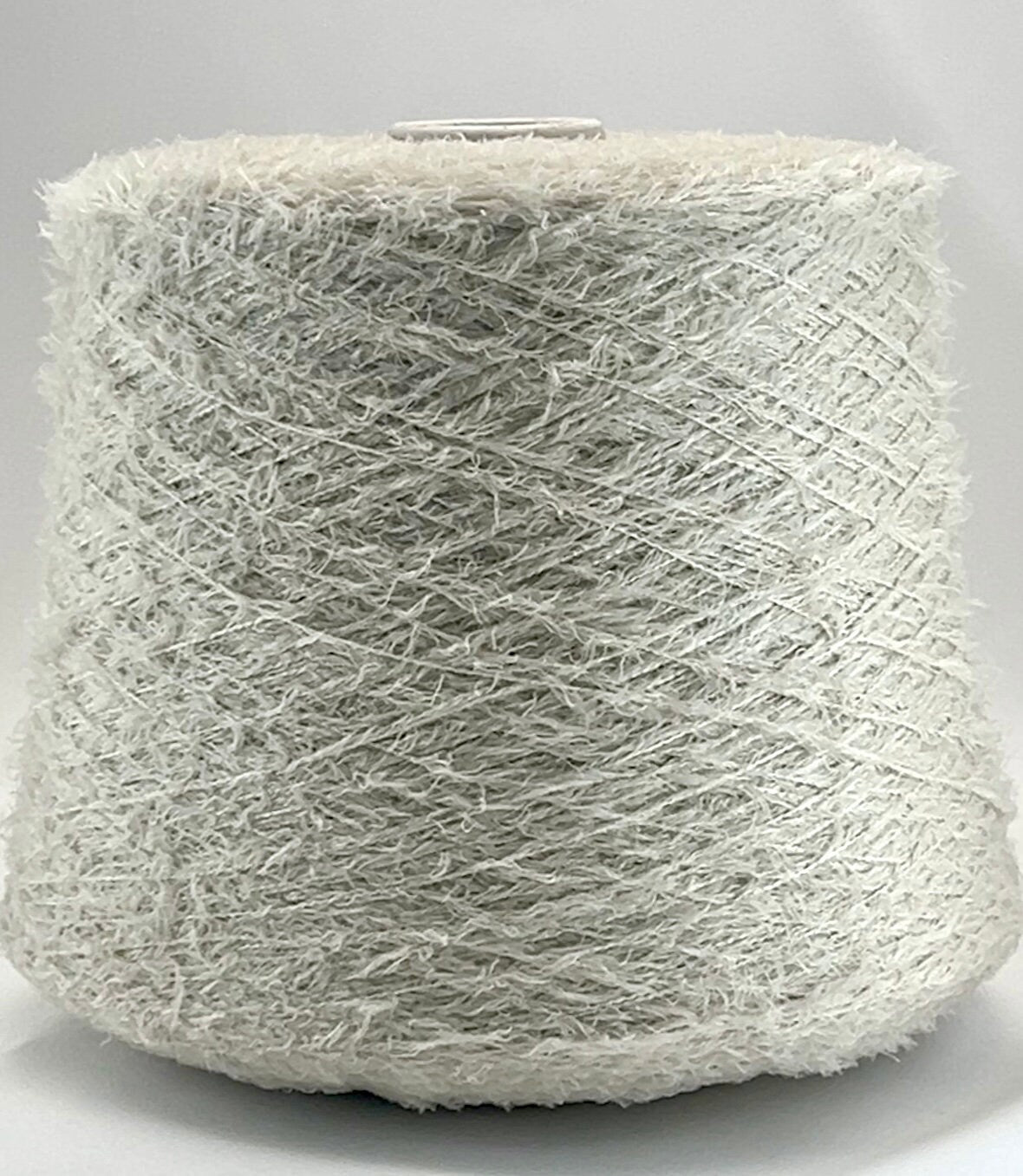 Spool of gray yarn on a white background
