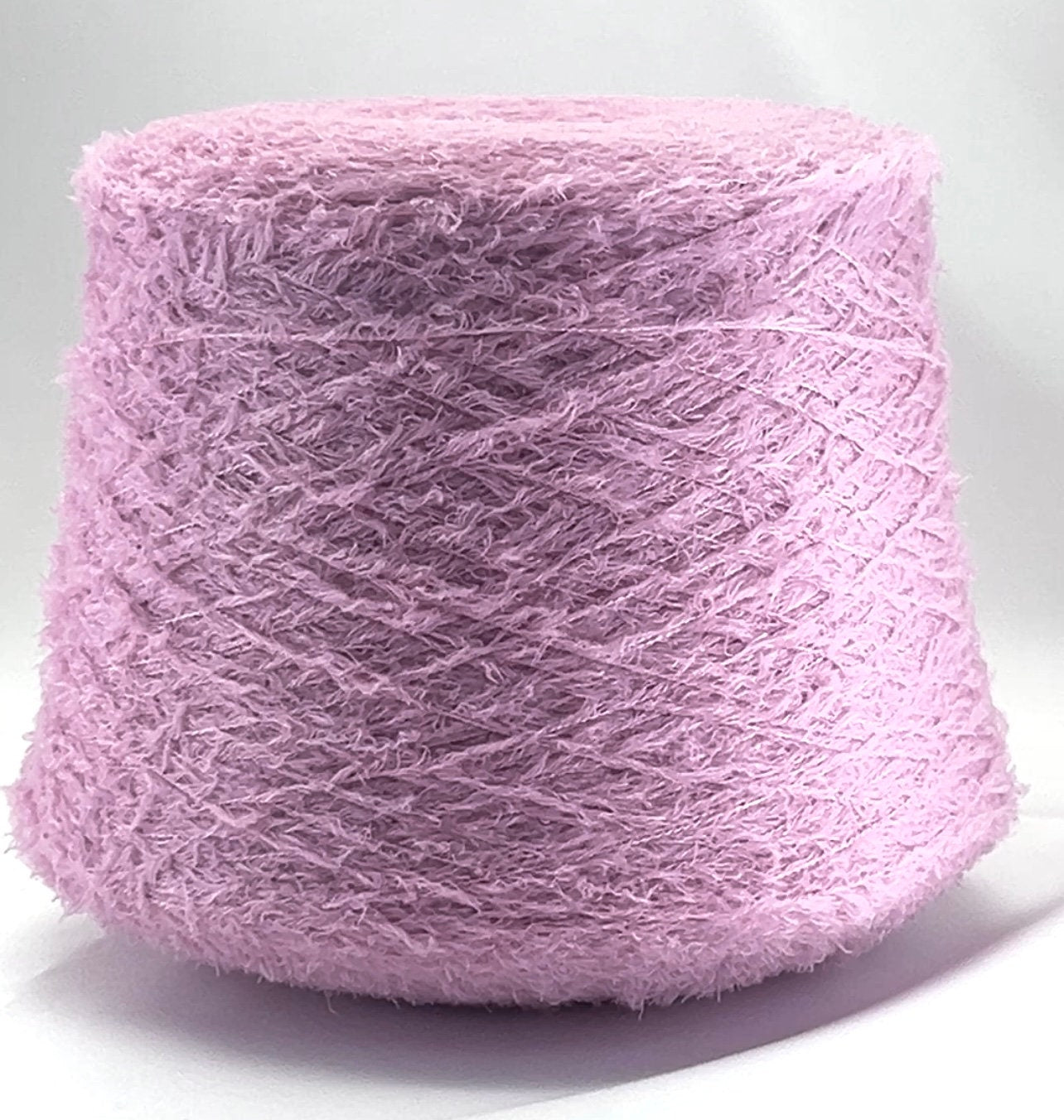 Pink skein of yarn on a white background
