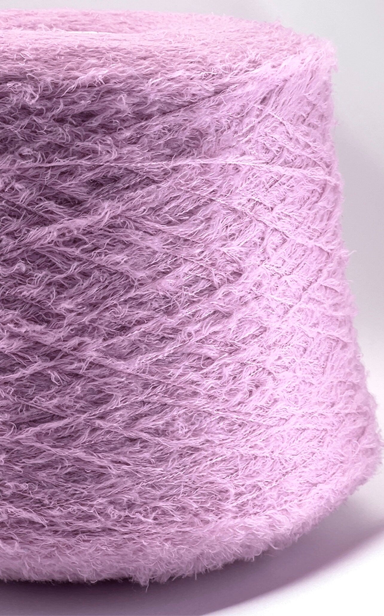 Close-up of a pink skein of yarn on a white background