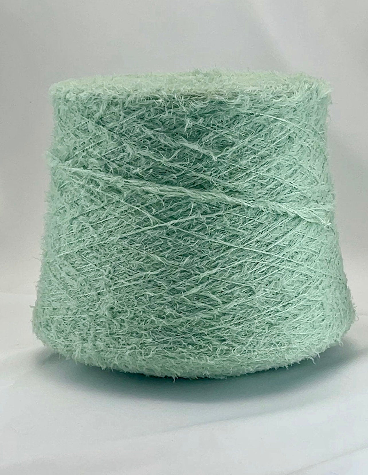 Light green skein of yarn on a white background