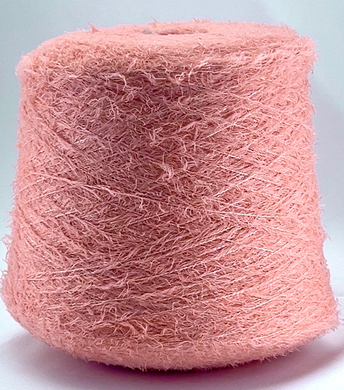 Pink yarn ball on a light gray background