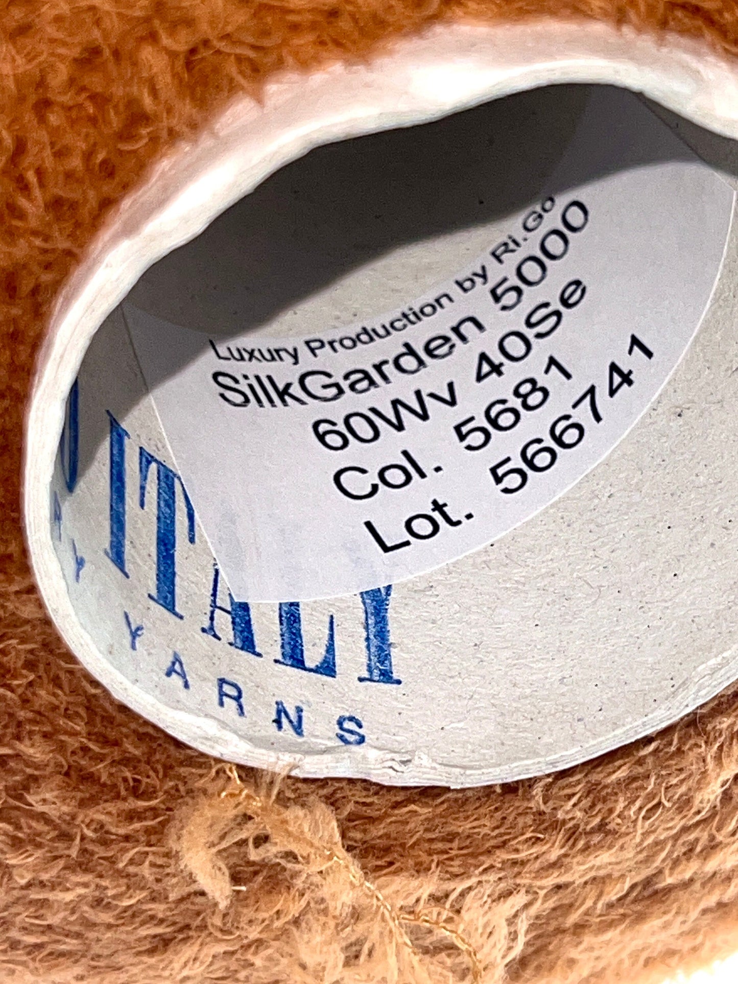 Close-up of a label on a ball of yarn with brand and product details.