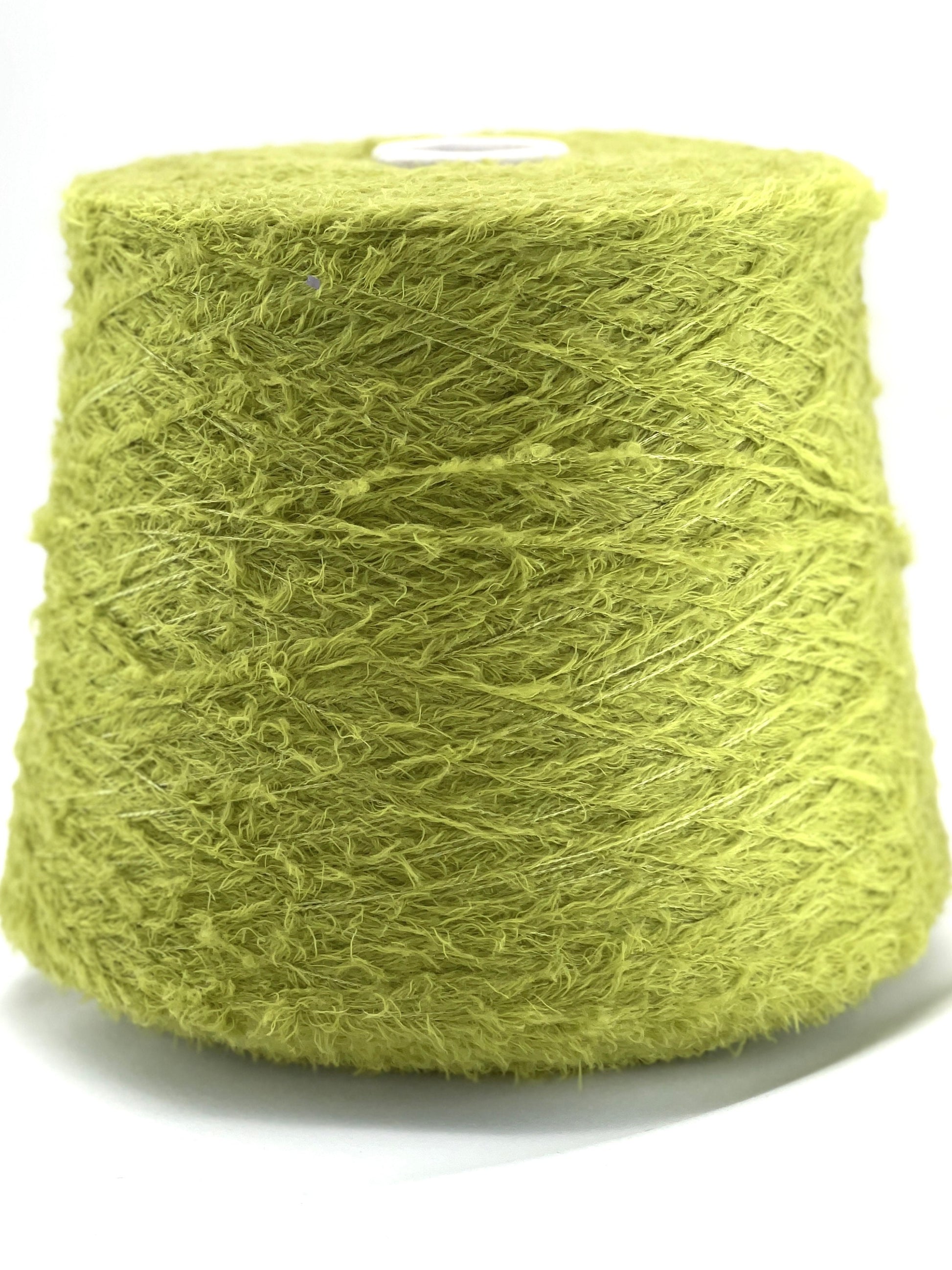 Spool of green yarn on a white background
