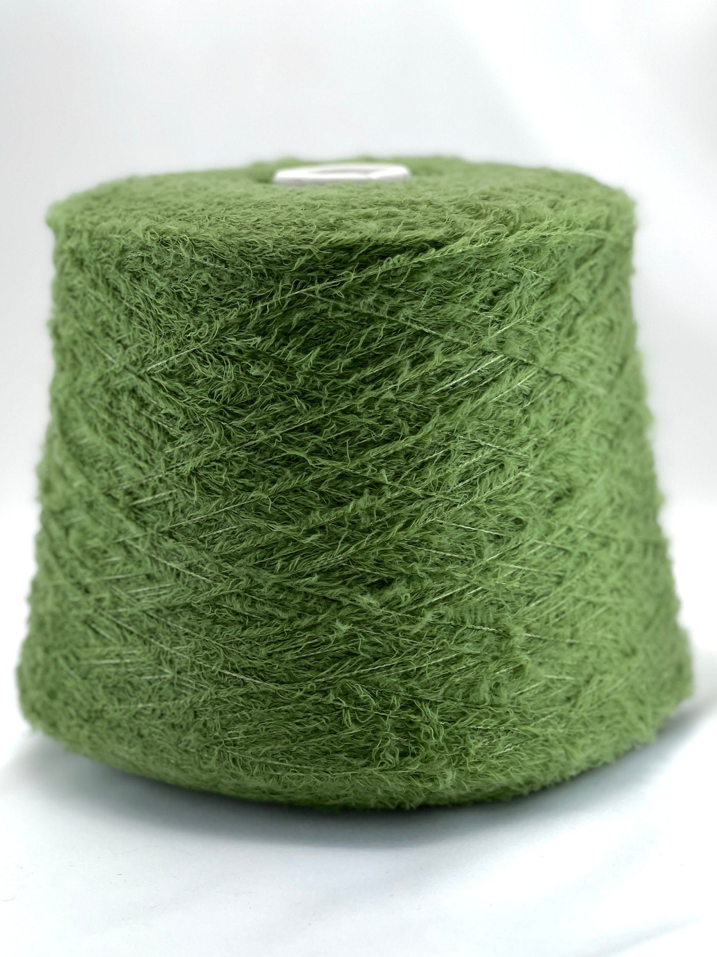 Green yarn ball on a white background