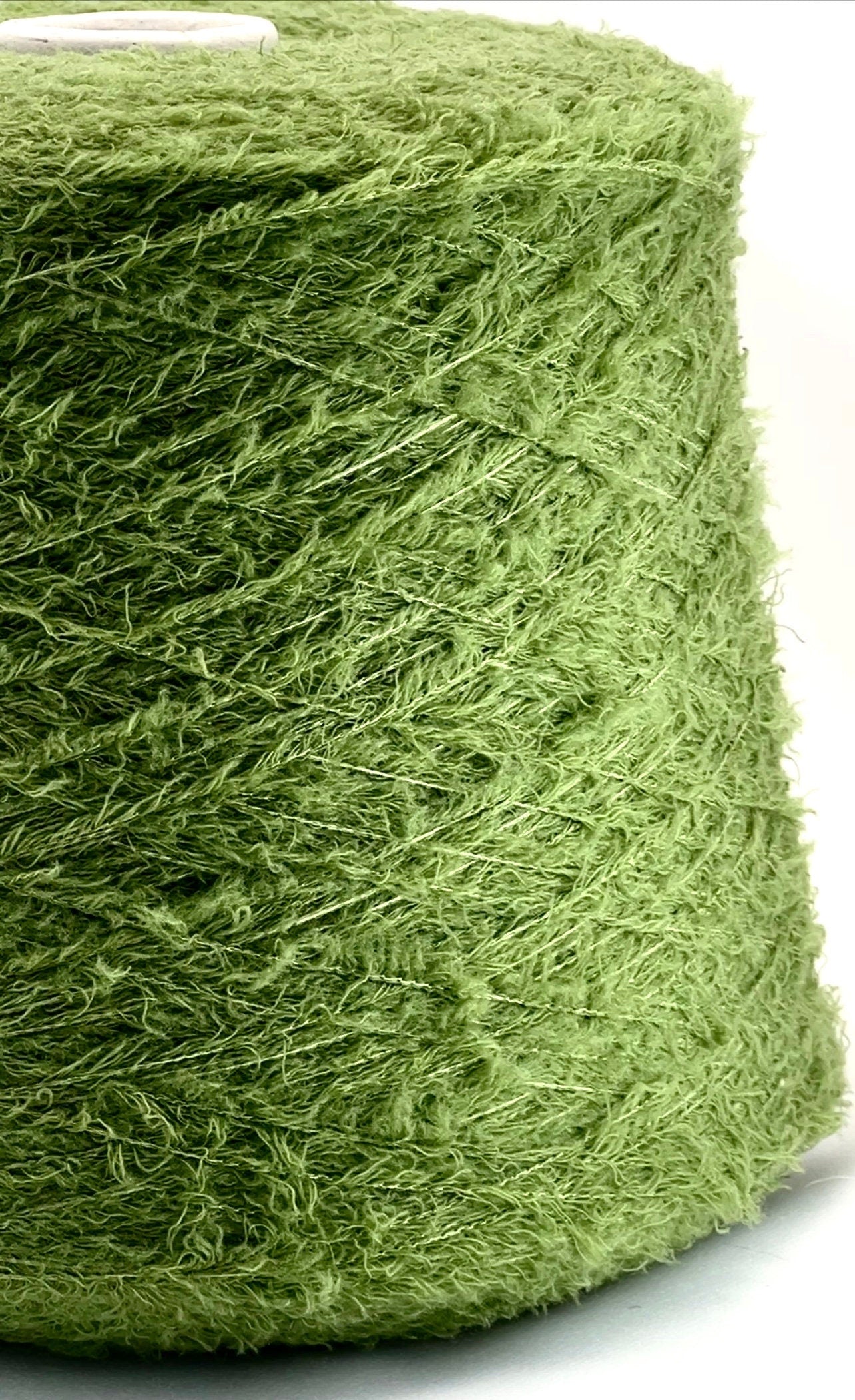 Close-up of a green skein of yarn on a white background