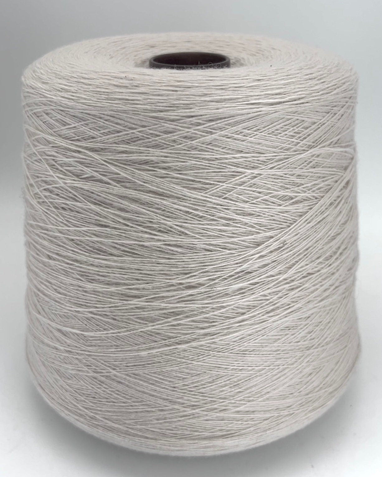 Spool of gray yarn on a white background
