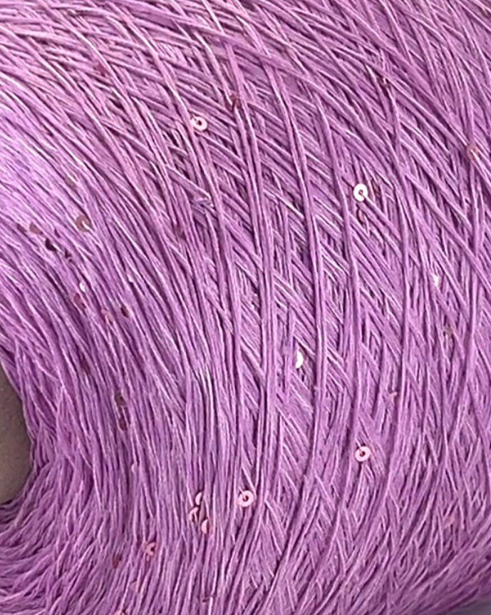Close-up of a purple yarn ball with visible fibers
