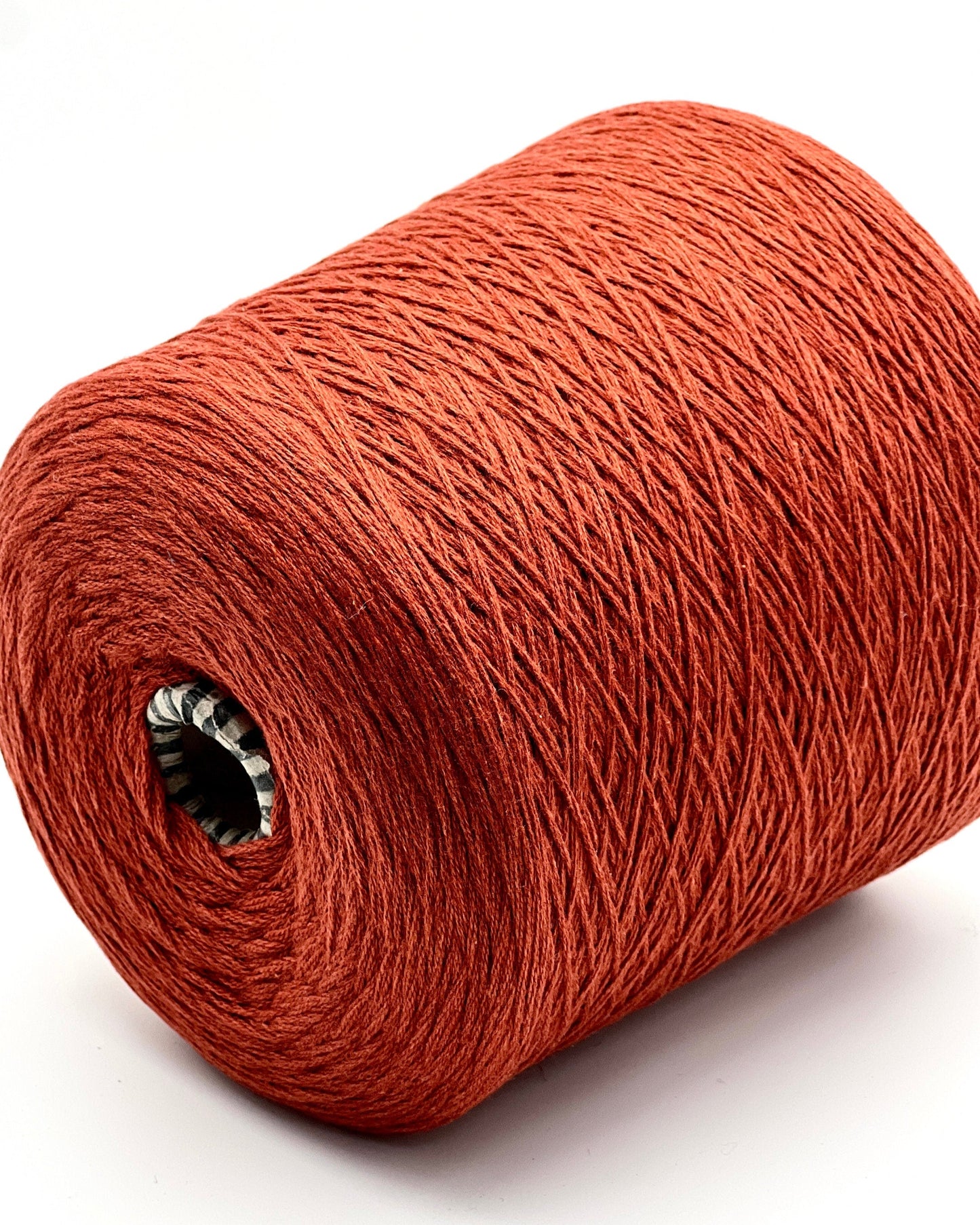 Red yarn roll on a white background