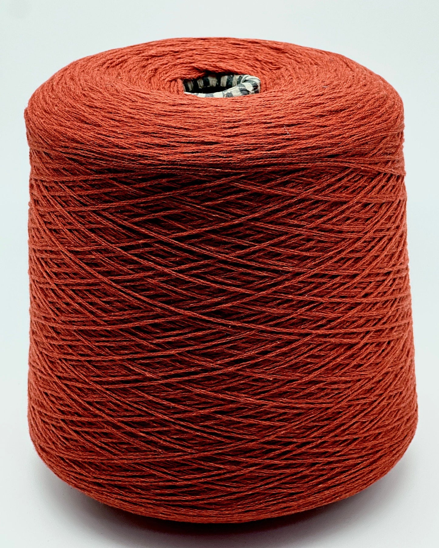Red spool of yarn on a white background