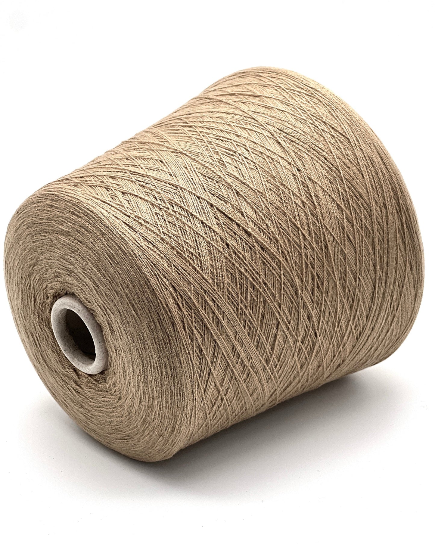 Spool of beige yarn on a white background
