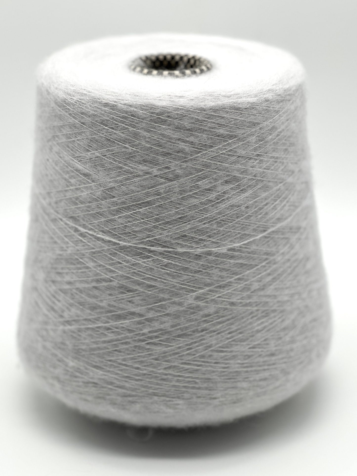 Spool of gray yarn on a white background