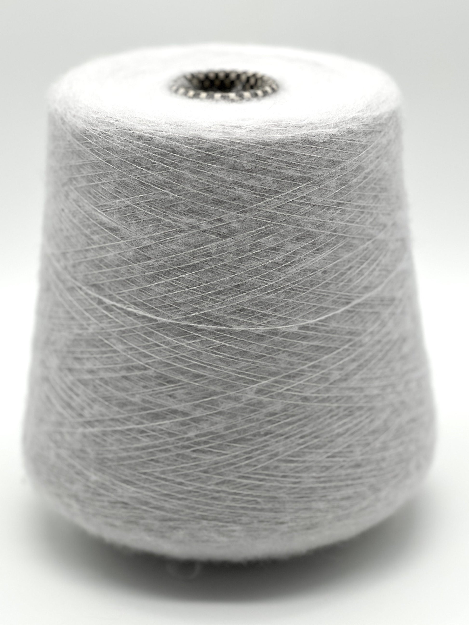 Spool of gray yarn on a white background