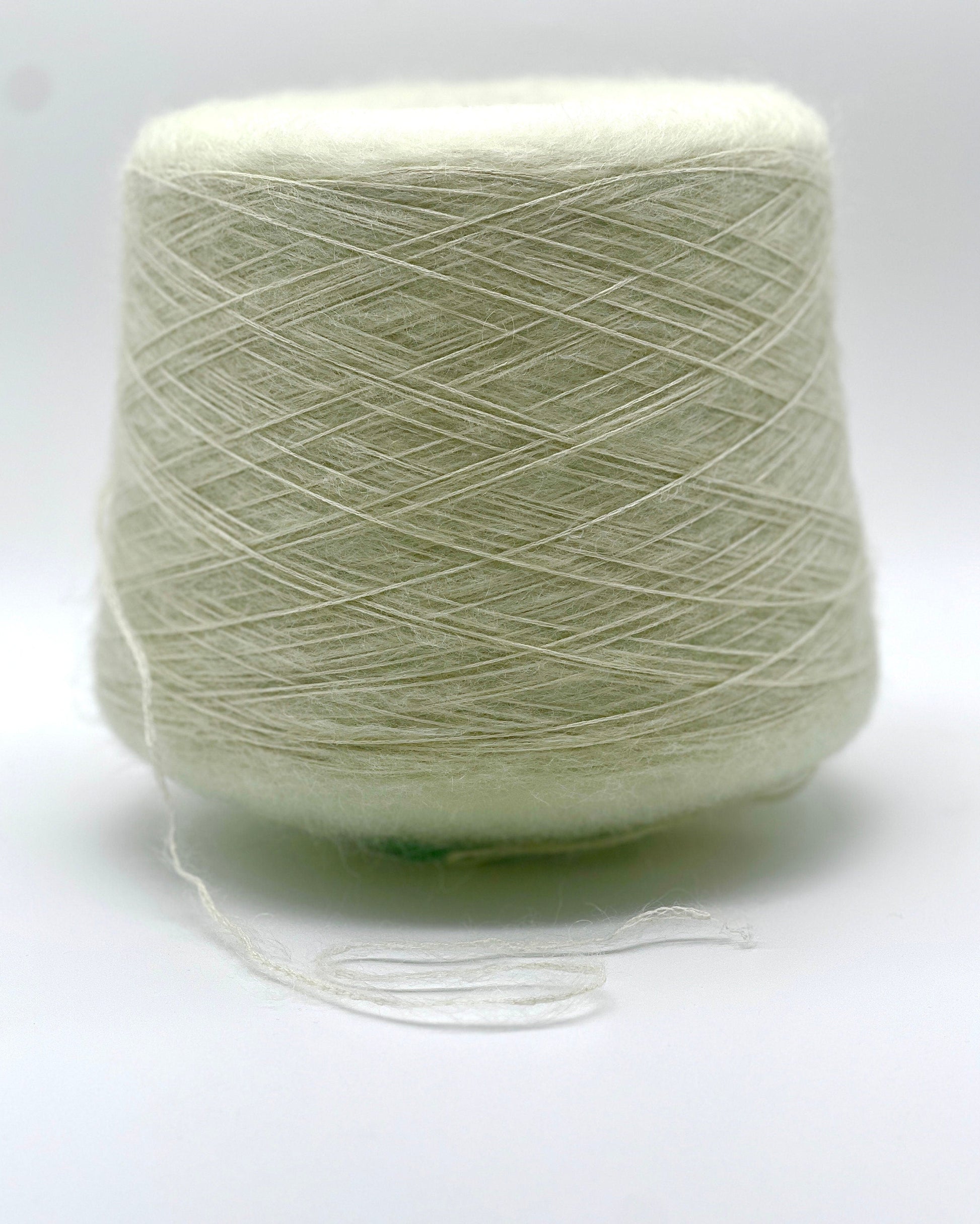 Light green skein of yarn on a white background
