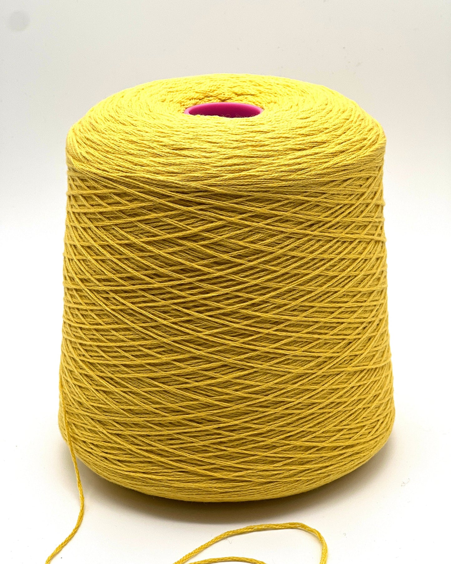 Yellow spool of yarn on a white background
