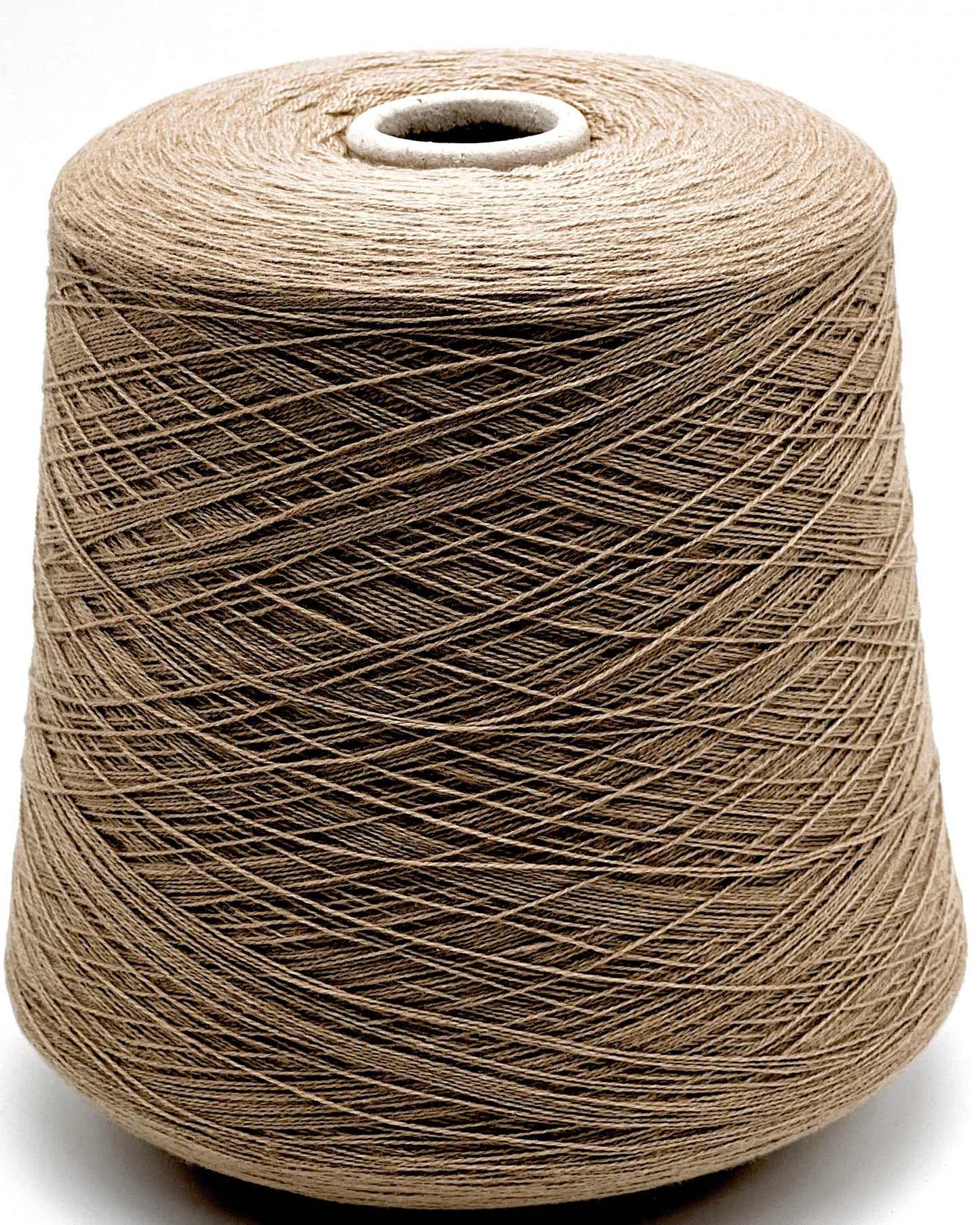 Spool of brown thread on a white background